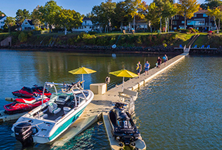 A long floating dock that leads to several boat and PWC ports